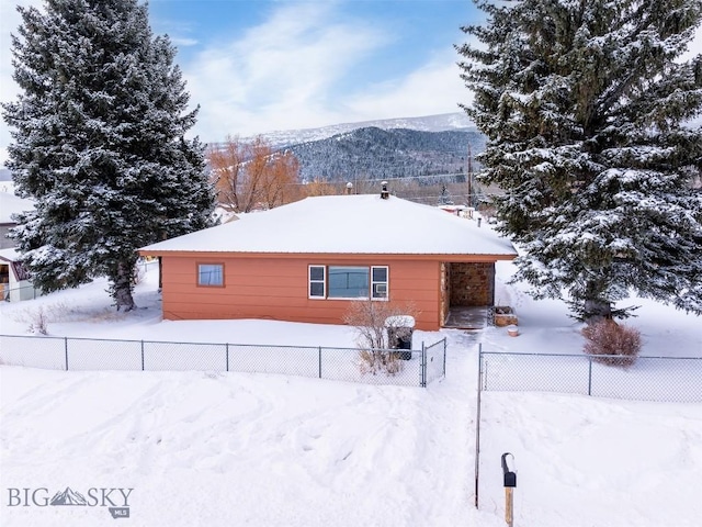 snow covered house with a mountain view