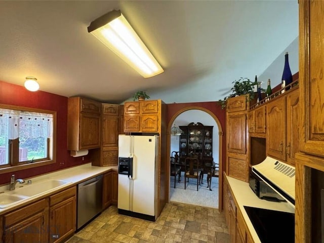 kitchen with dishwasher, sink, and white fridge with ice dispenser