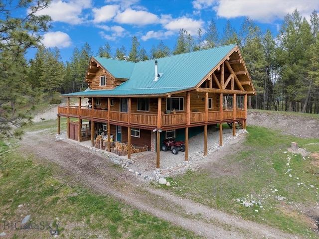 rear view of property featuring a deck