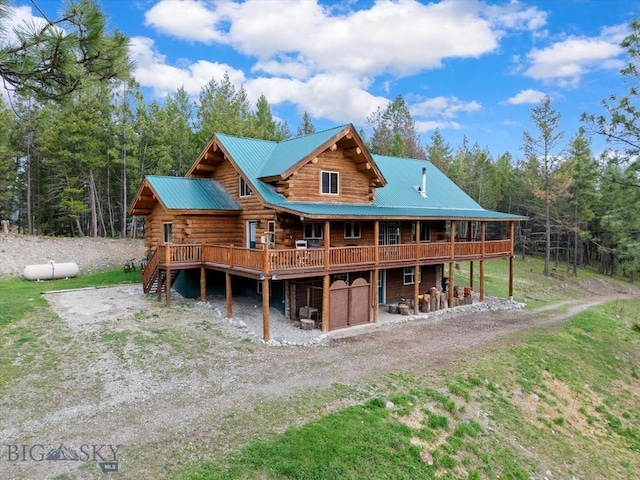 rear view of property featuring a wooden deck