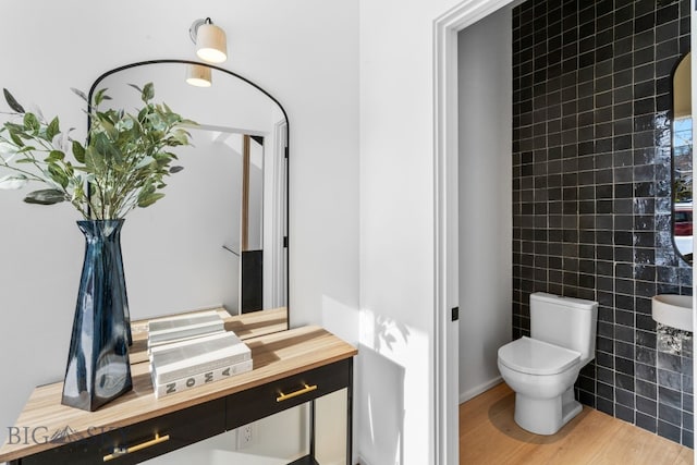 217 W Beall St Unit B, Bozeman, MT 59715 - bathroom featuring wood finished floors, tile walls, and vanity