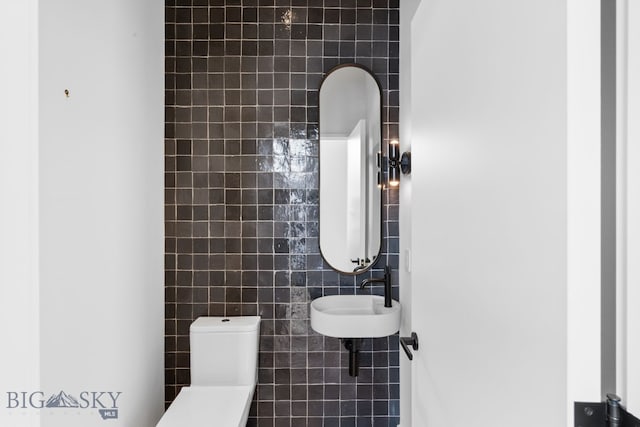 217 W Beall St Unit B, Bozeman, MT 59715 - half bathroom featuring tile walls and a sink