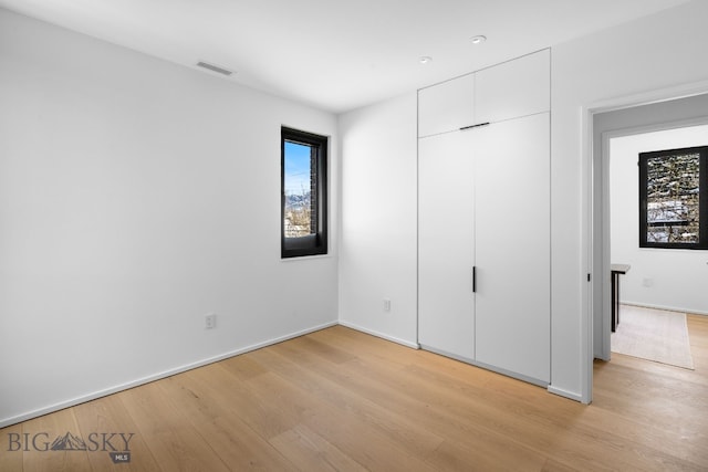 217 W Beall St Unit B, Bozeman, MT 59715 - unfurnished bedroom featuring light wood finished floors and a closet
