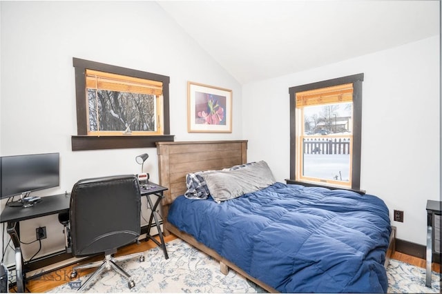 bedroom featuring lofted ceiling and hardwood / wood-style flooring