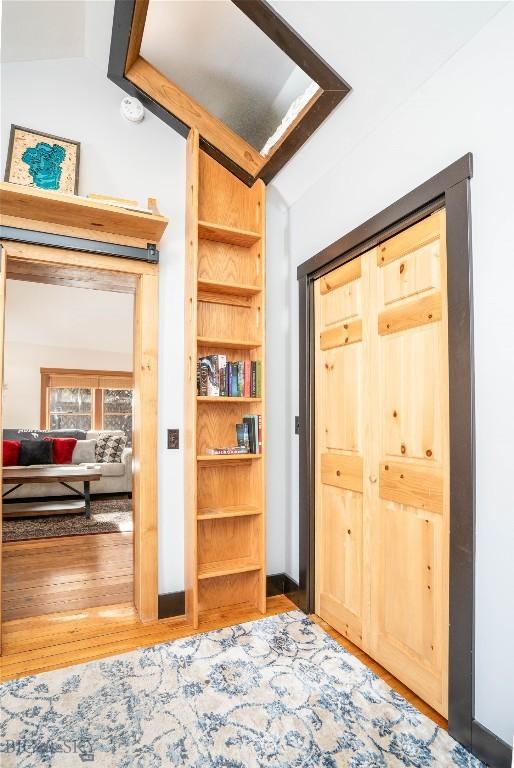 interior space with lofted ceiling and hardwood / wood-style floors