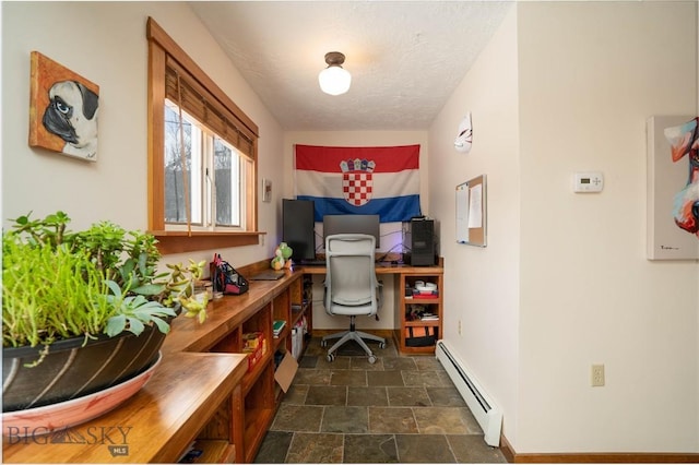 interior space featuring a textured ceiling and a baseboard heating unit