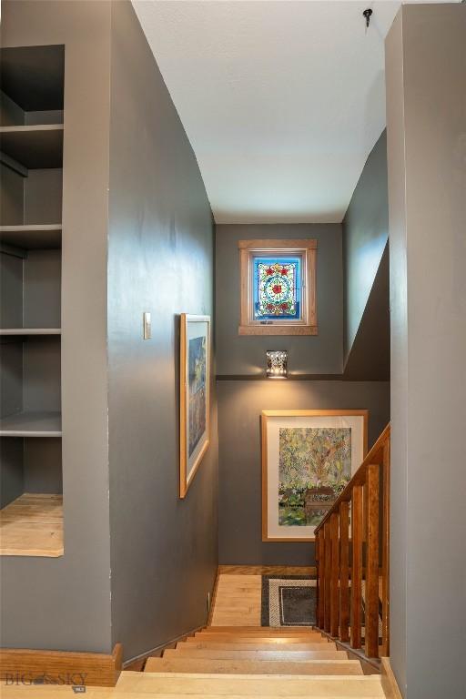 staircase with hardwood / wood-style flooring