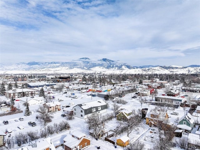 snowy aerial view with a mountain view