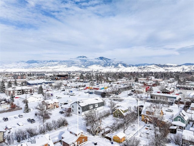 snowy aerial view with a mountain view