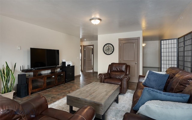 living area with stone finish flooring and baseboards