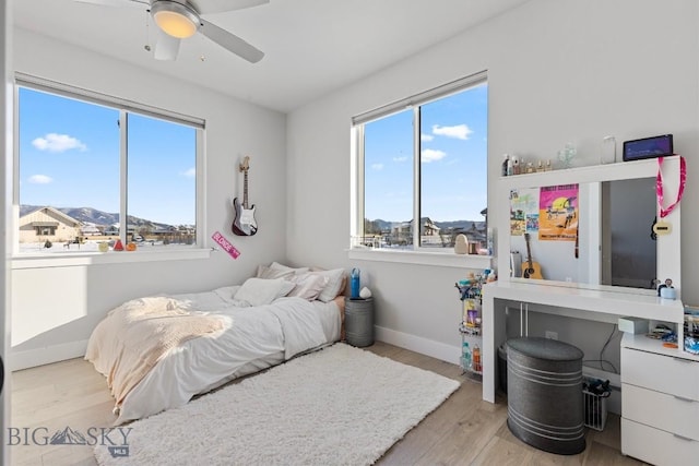 bedroom with ceiling fan and light wood-type flooring