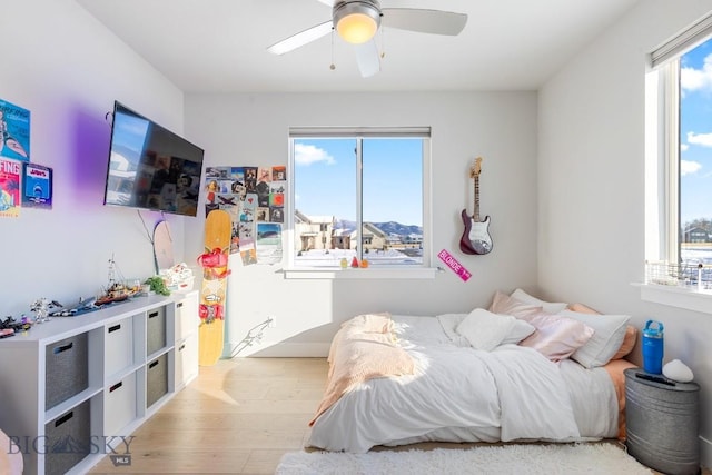 bedroom with ceiling fan and light wood-type flooring