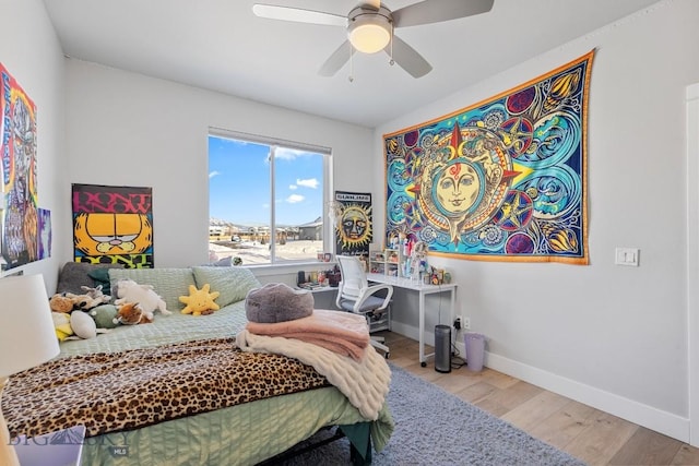 bedroom with ceiling fan and light wood-type flooring