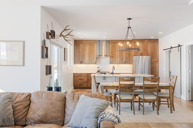 dining space featuring a barn door and sink