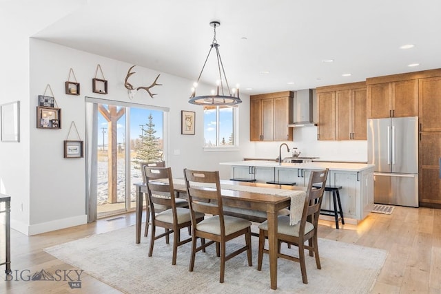 dining space featuring an inviting chandelier and light wood-type flooring