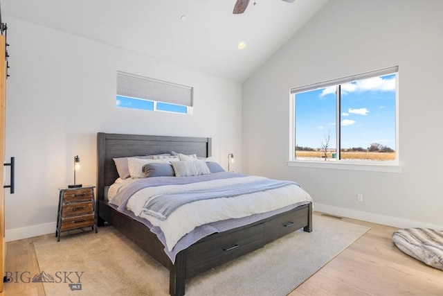 bedroom featuring vaulted ceiling, ceiling fan, and light wood-type flooring