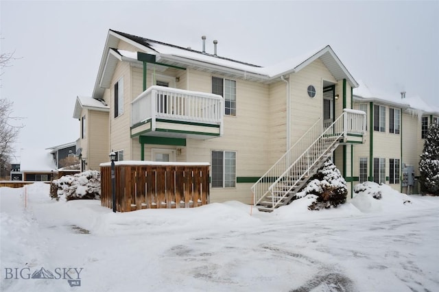 view of snow covered rear of property