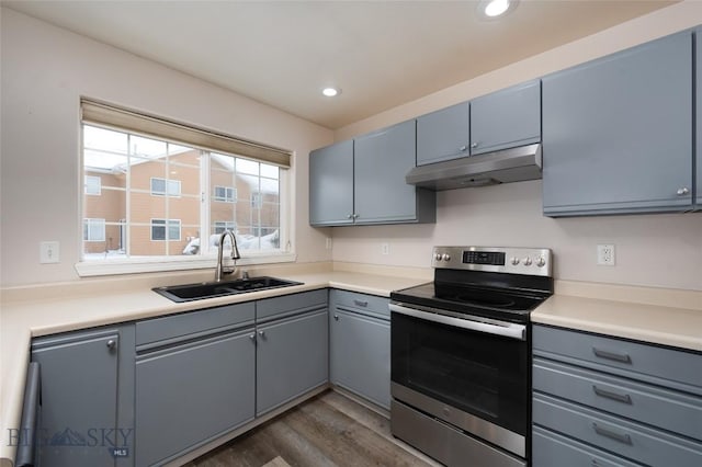 kitchen featuring electric stove, sink, and dark hardwood / wood-style flooring