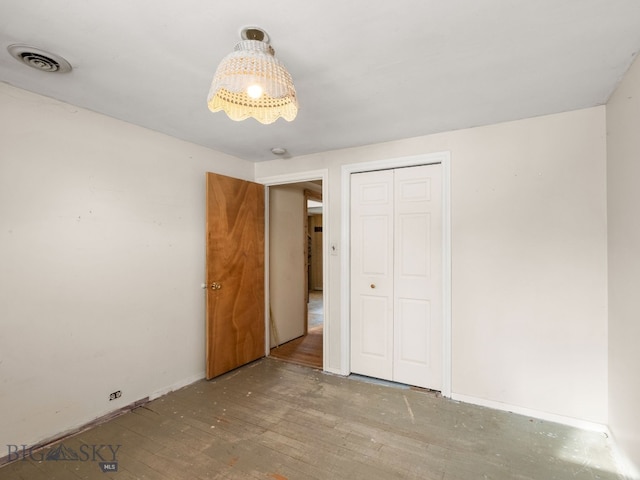 509 E Railroad N, Manhattan, MT 59741 - unfurnished bedroom with wood finished floors, a closet, and baseboards