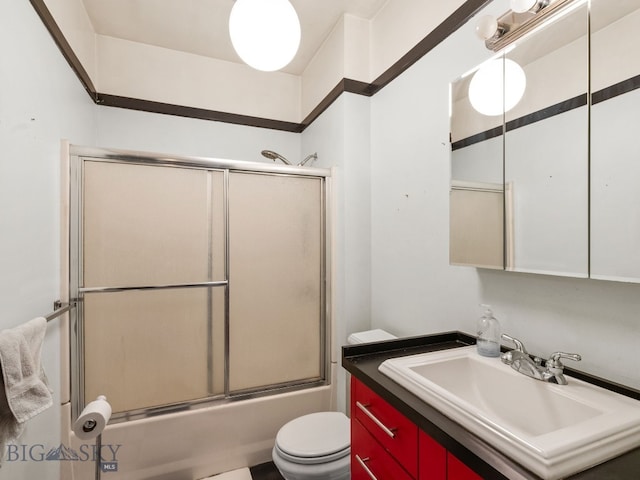 full bathroom featuring bath / shower combo with glass door, vanity, and toilet