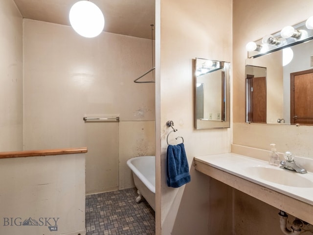 bathroom with sink and a tub to relax in