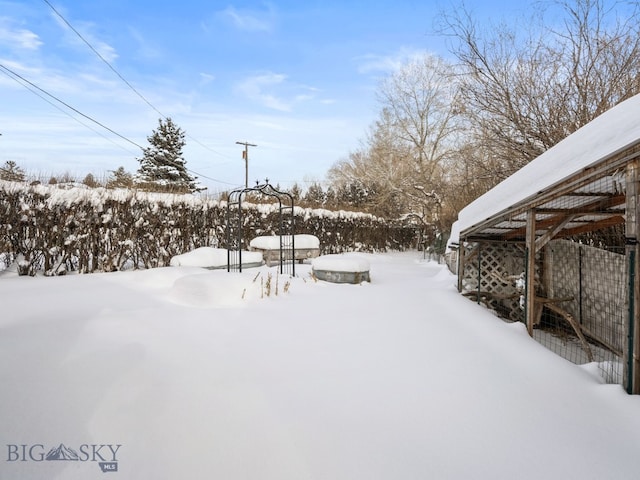 view of yard layered in snow