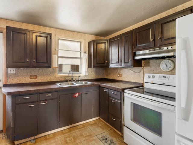 kitchen with dark brown cabinetry, sink, backsplash, and white appliances