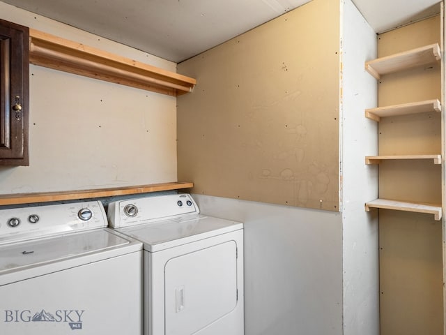 clothes washing area with washing machine and clothes dryer