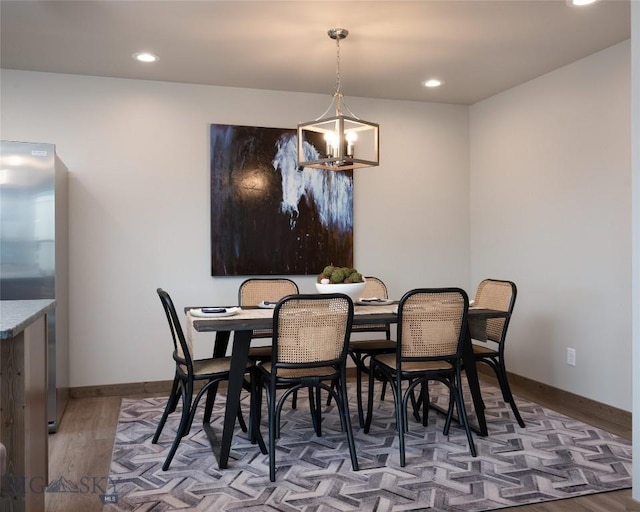 dining space featuring a chandelier and hardwood / wood-style floors