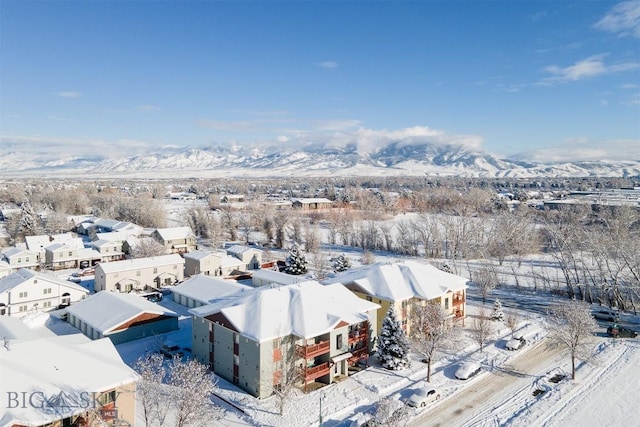 snowy aerial view with a mountain view