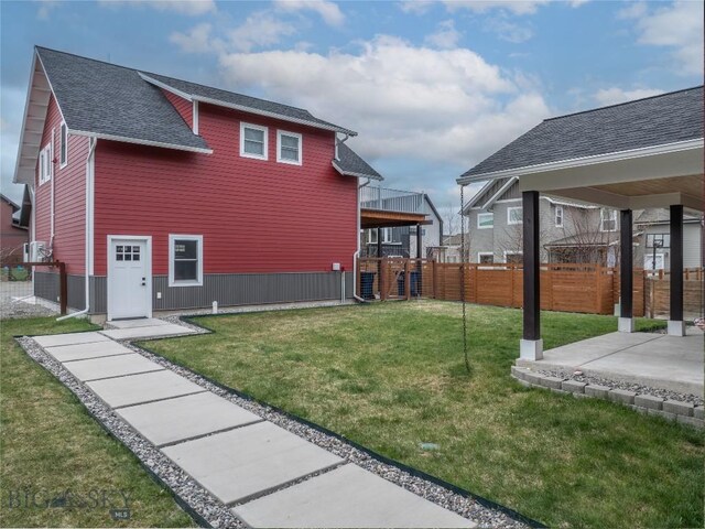 4562 Bembrick St, Bozeman, MT 59718 - exterior space with fence, a lawn, roof with shingles, and a patio