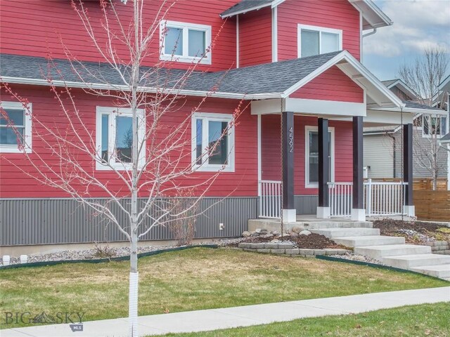 4562 Bembrick St, Bozeman, MT 59718 - view of front of house with roof with shingles, a front yard, and covered porch