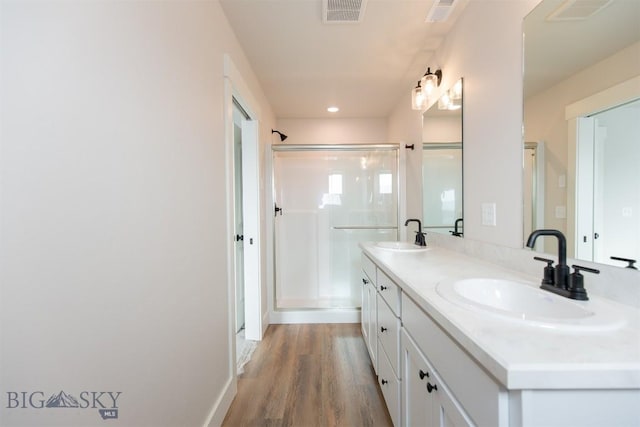 bathroom featuring an enclosed shower, hardwood / wood-style floors, and vanity