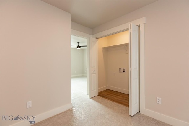 hallway featuring light colored carpet