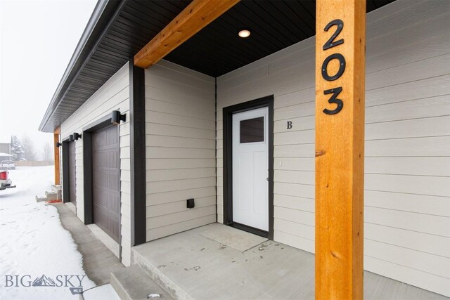 view of snow covered property entrance