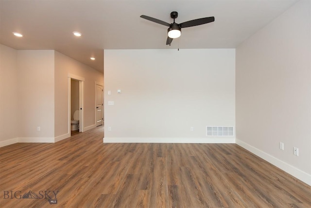 empty room featuring dark hardwood / wood-style flooring and ceiling fan