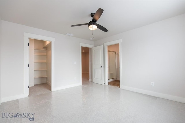 unfurnished bedroom featuring a spacious closet, connected bathroom, ceiling fan, and a closet