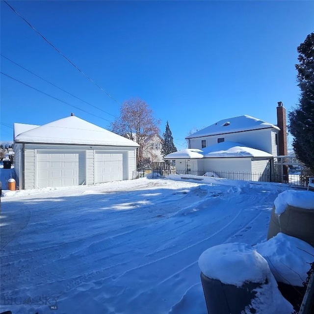 exterior space with a garage and an outdoor structure