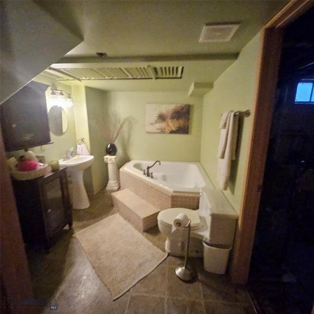 bathroom with a washtub and sink