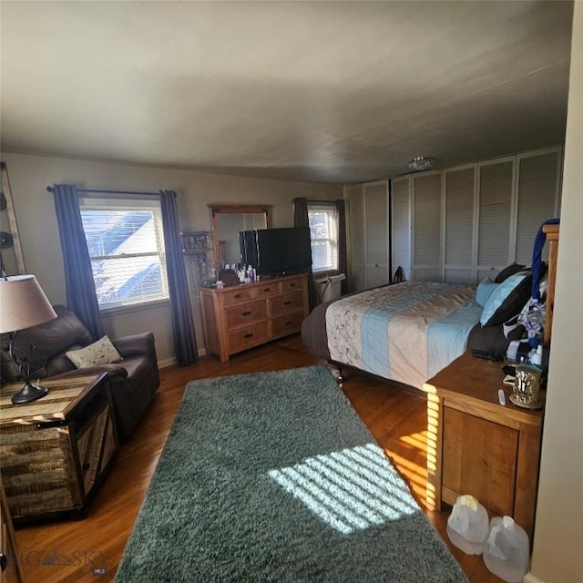 bedroom with dark wood-type flooring