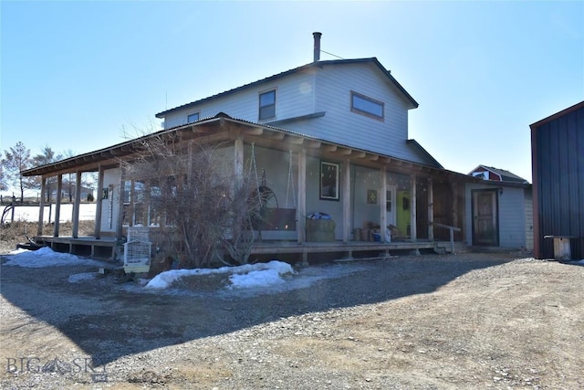 farmhouse featuring metal roof and covered porch