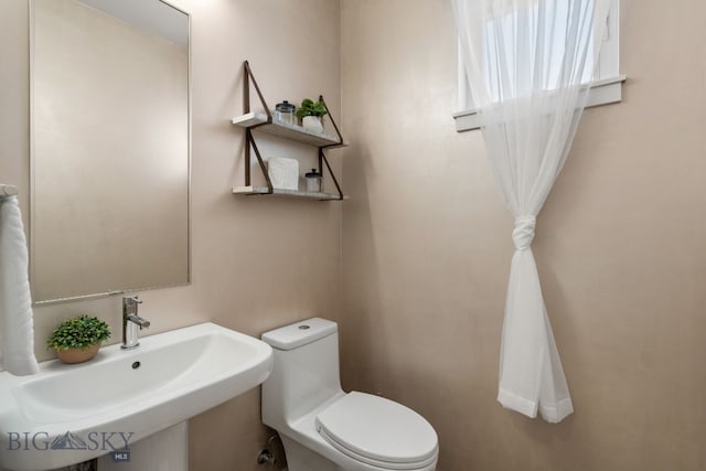 bathroom with sink and toilet