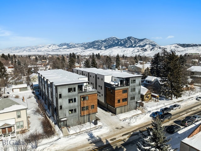 snowy aerial view with a mountain view