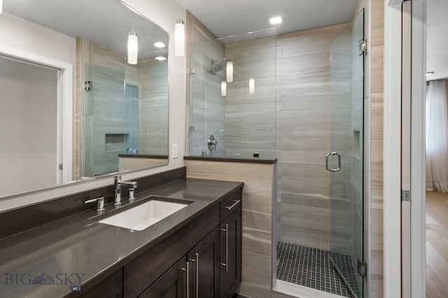 bathroom featuring an enclosed shower and vanity