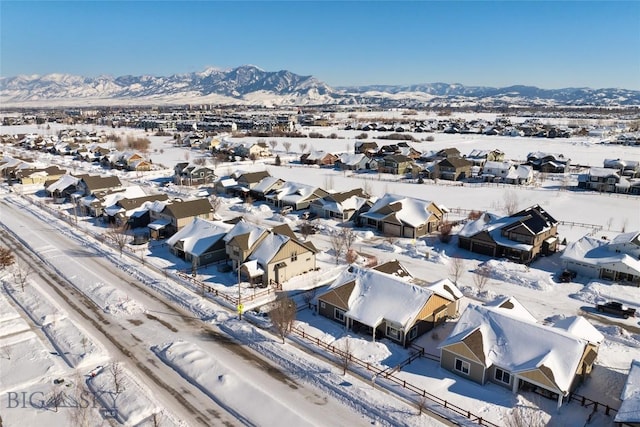 snowy aerial view featuring a mountain view