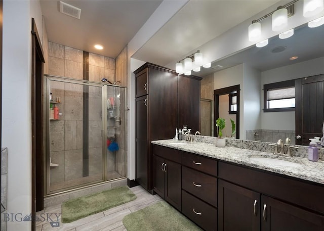 bathroom with vanity and an enclosed shower