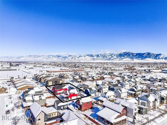 snowy aerial view with a mountain view