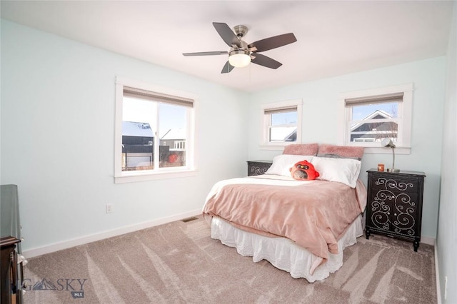 bedroom featuring ceiling fan and light carpet