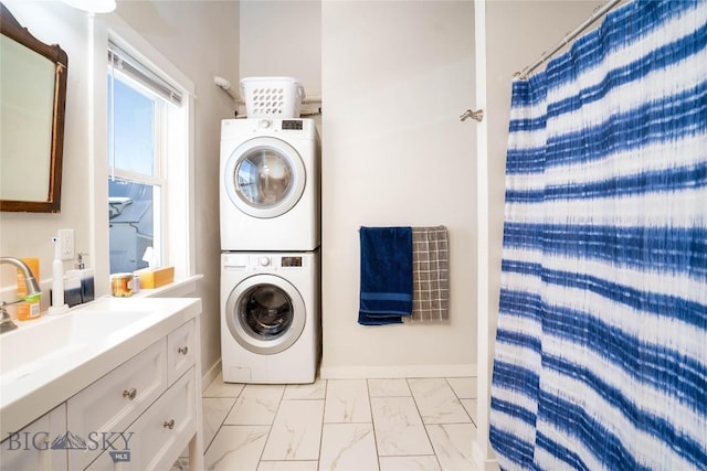 laundry room featuring stacked washer and dryer and sink