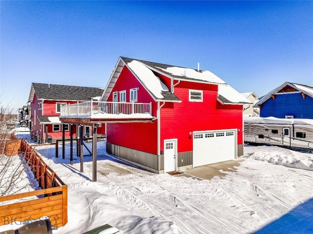 view of front of home featuring a garage and a balcony